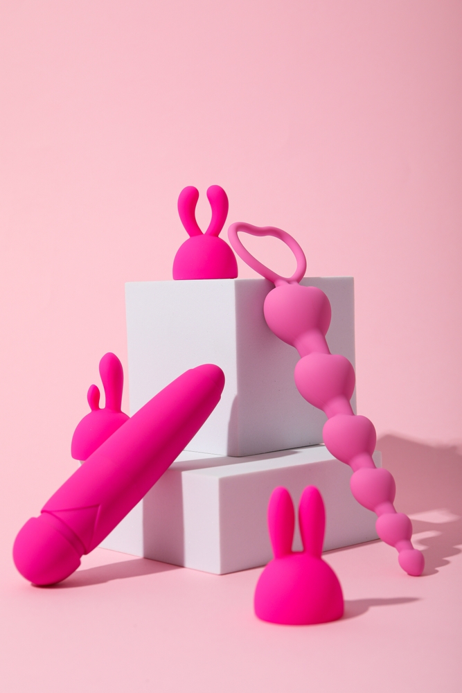Composition,Of,Pink,Sex,Toys,With,Cubes,On,A,Pink